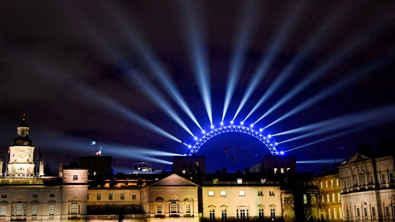 The London Eye is seen illuminated ahead of the New Year&#39;s Eve celebrations, in central London, Britain, December 31, 2022. REUTERS/Toby Melville