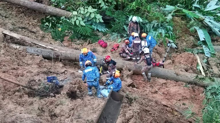 In this photo provided by Civil Defense Department, Civil Defense personnel search for missing persons after a landslide hit a campsite in Batang Kali, Malaysia, Friday, Dec. 16, 2022. A landslide hit the campsite outside Kuala Lumpur early Friday, Malaysia&#39;s fire department said. (Malaysia Civil Defense via AP )