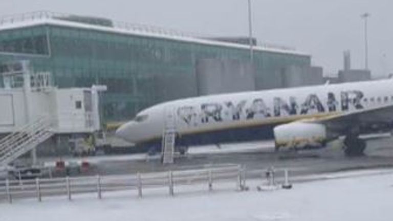 Both runways have been closed at Manchester airport, leaving passengers waiting on planes in the snow