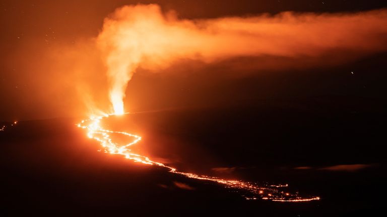 Lava fountains and flows illuminate the area with a glow at the Mauna Loa volcano eruption in Hawaii, U.S. December 2, 2022. REUTERS/Go Nakamura
