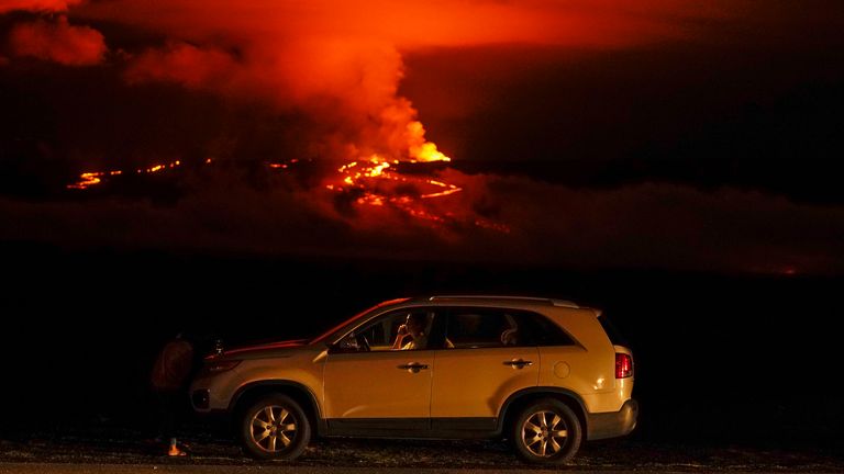 A man talks on a phone in his car alongside Saddle Road as the Mauna Loa volcano erupts Wednesday, Nov. 30, 2022, near Hilo, Hawaii. Hundreds of people in their cars lined Saddle Road, which connects the east and west sides of the island, as lava flowed down the side of Mauna Loa and could be seen fountaining into the air on Wednesday
PIC:AP