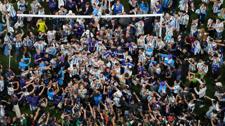 Argentina's Lionel Messi is surrounded by players, fans and photographers as his team celebrates