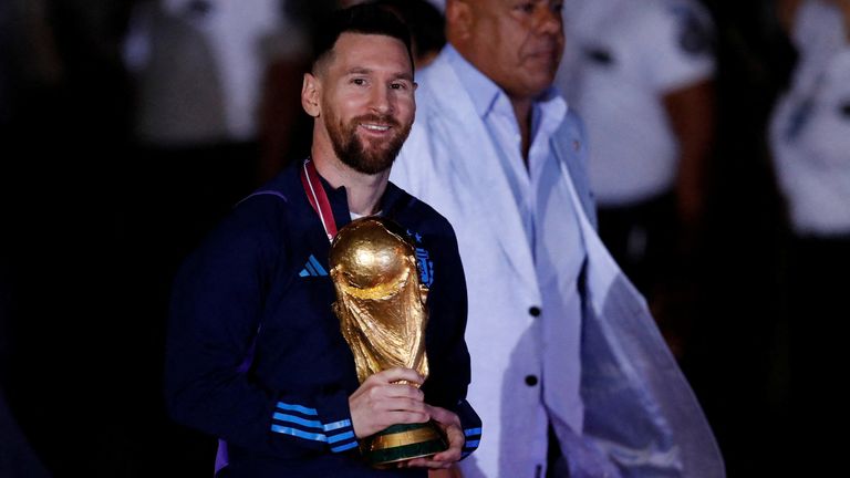 Lionel Messi with the trophy during the team&#39;s arrival. Pic: Reuters
