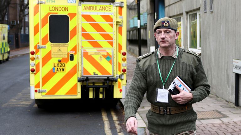 A member of the military walks nearby an ambulance, on the day ambulance workers strike amid a dispute with the government over pay, near the NHS London Ambulance Service, in London, Britain December 21, 2022. REUTERS/Henry Nicholls
