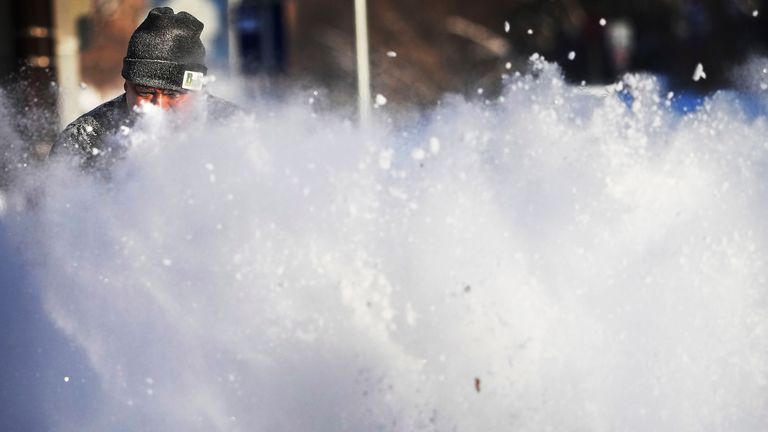 Javier Galicia clears snow from a sidewalk in Minneapolis
PIC:Star Tribune/AP