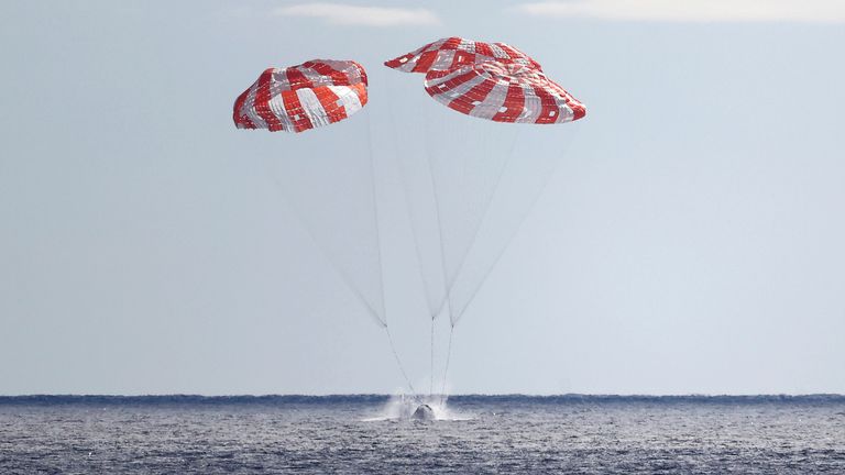 NASA&#39;s Orion capsule splashes down Sunday, Dec. 11, 2022, to conclude a dramatic 25-day test flight, as seen from aboard the U.S.S. Portland in the Pacific off Mexico. The mission should clear the way for astronauts on the program...s next lunar flyby, set for 2024. (Mario Tama/Pool Photo via AP)