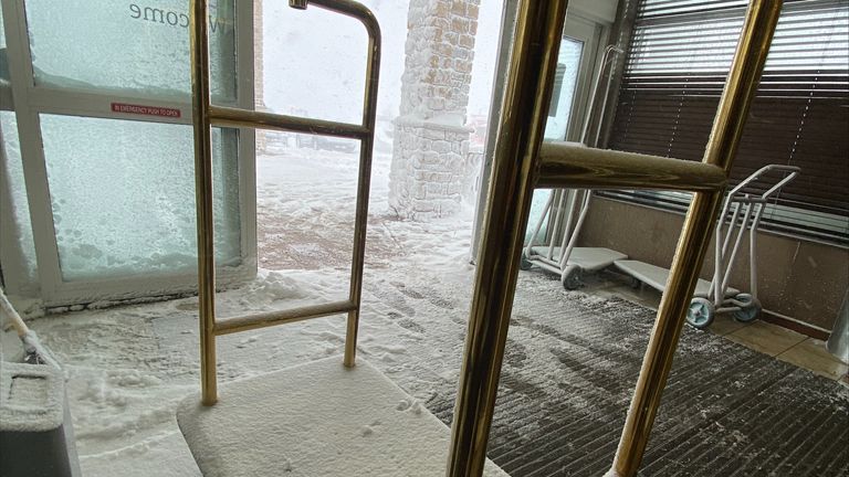 Snow covers luggage carts at a hotel in Watertown, New York