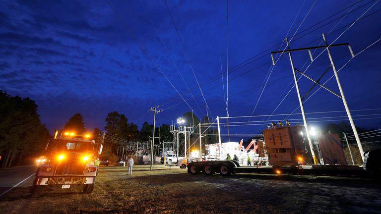 Duke Energy personnel work to restore power at a crippled electrical substation that the workers said was hit by gunfire after the Moore County Sheriff said that vandalism caused a mass power outage, in Carthage, North Carolina, U.S. December 4, 2022. REUTERS/Jonathan Drake