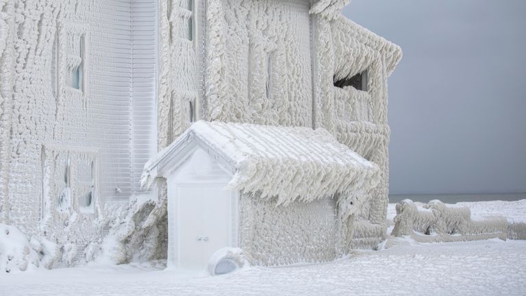 Houses along the shores of Lake Erie, near Fort Erie, Ontario, remain covered in ice Tuesday, Dec. 27, 2022, following a winter storm that swept through much of Ontario. 
PIC:AP