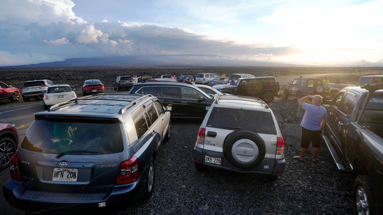 An overflow of cars sit in a parking lot near the Mauna Loa volcano as it erupts Wednesday, Nov. 30, 2022, near Hilo, Hawaii. 
PIC:AP