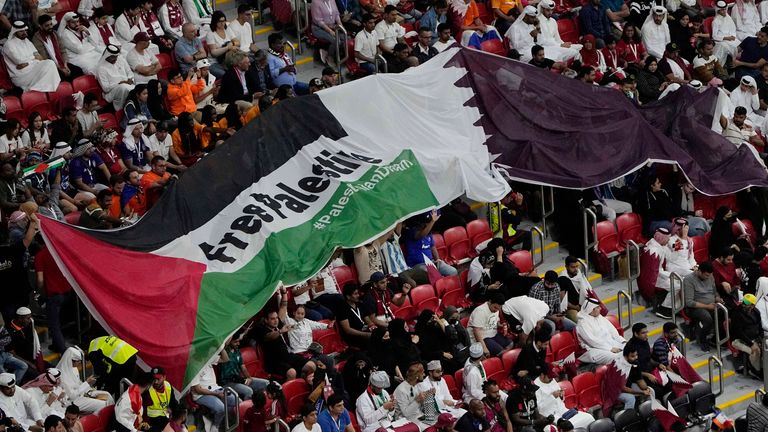 Supporters show a flag reading "Free Palestine" on the tribune during the World Cup group A soccer match between the Netherlands and Qatar, at the Al Bayt Stadium in Al Khor , Qatar, Tuesday, Nov. 29, 2022. (AP Photo/Ariel Schalit)