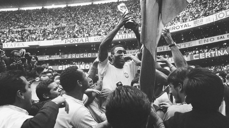 Brazil&#39;s Pele holds aloft the World Cup following victory over Italy in 1970. Pic: AP