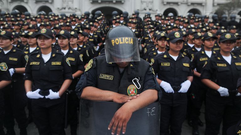 Police block protesters in Lima on Friday