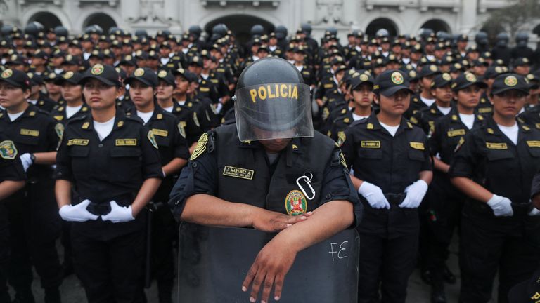 Police stop protesters in Lima on Friday