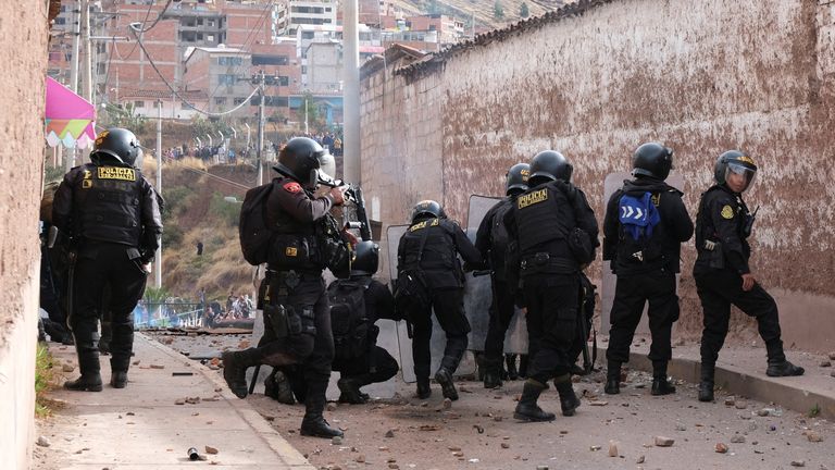 Police officers use their shields as people protest demanding the dissolution of the Congress and to hold democratic elections rather than recognizing Dina Boluarte as Peru&#39;s President, after the ouster of Peruvian President Pedro Castillo, in Cuzco, Peru December 14, 2022. REUTERS/Alejandra Orosco NO RESALES. NO A