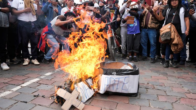 People take pictures of a fire during a protest demanding the dissolution of the National Assembly and holding democratic elections instead of recognizing Dina Boluarte as the President of Peru, after Peruvian President Pedro Castillo was ousted, in Cuzco, Peru today. December 14, 2022 REUTERS/Alejandra Orosco NO RESELLER.  NO STORAGE