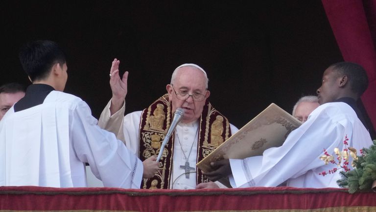 Pope Francis pronounces the Urbi et Orbi (Latin for "to the city and the world") Christmas"  blessing of the day from the main balcony of St. Peter's Basilica in the Vatican, Sunday, Dec. 25, 2022. (AP Photo/Gregorio Borgia)