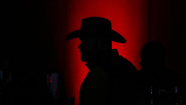 A supporter walks in the hall during an election night watch party for Republican candidate Herschel Walker, Tuesday, Dec. 6, 2022, in Atlanta. Georgia voters are deciding the final Senate contest in the country, choosing between Democratic Sen. Raphael Warnock and Republican candidate Herschel Walker. (AP Photo/Brynn Anderson)