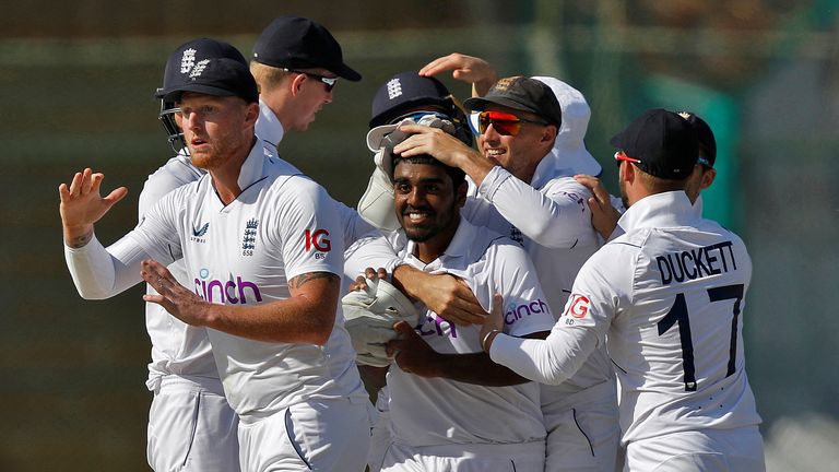 Ahmed&#39;s teammates congratulated him as he took his first Test wicket