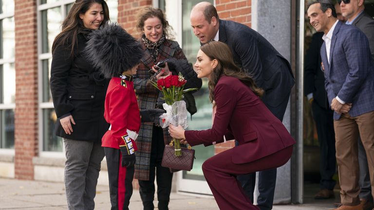 The Prince and Princess of Wales are presented with flowers by Henry Dynov-Teixeira, aged 8, dressed as a Guardsman, during a visit to the Greentown Labs in Somerville, to learn about climate innovations which are being incubated in Boston