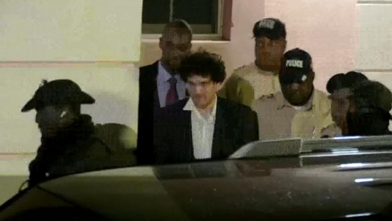 Sam Bankman-Fried is led from a courthouse in the Bahamas