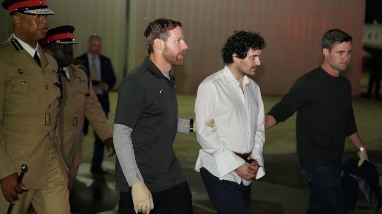 Sam Bankman-Fried, founder and former CEO of crypto currency exchange FTX, is walked in handcuffs to a plane during his extradition to the United States at Lynden Pindling international airport in Nassau, Bahamas 
PIC:Royal Bahamas Police Force/ REUTERS