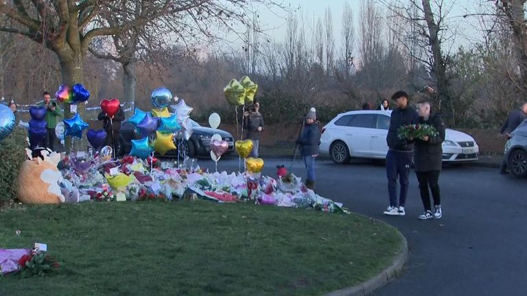 Aston Villa stars John McGinn and Tyrone Mings pay tribute at a makeshift memorial to the three boys who died after falling into an icy lake in Solihull