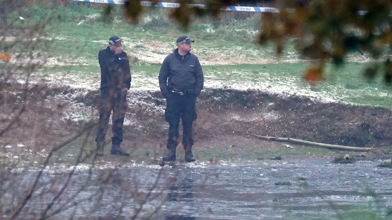 Police officers at the scene in Babbs Mill Park in Kingshurst, Solihull. Four children are in critical condition in hospital after being pulled from an icy lake in cardiac arrest, while a search operation continues amid fears two more children were involved in the incident. Picture date: Monday December 12, 2022.