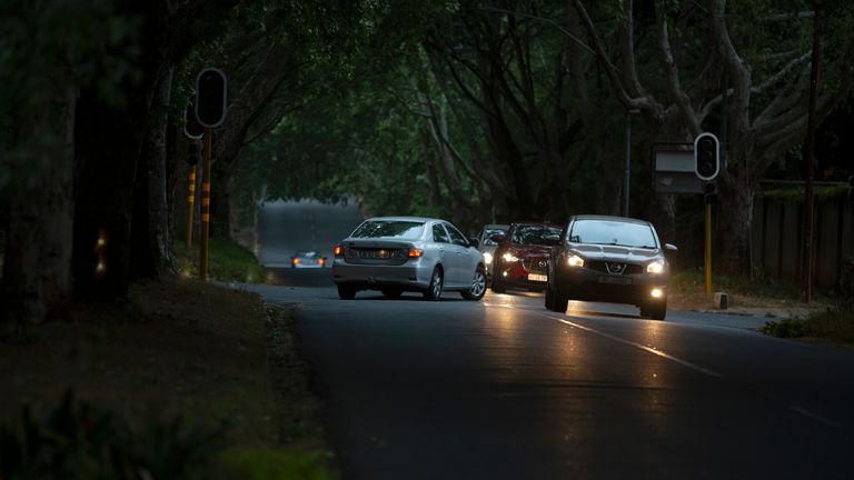 Cars drive above an intersection controlled by traffic lights during a power outage in Johannesburg.  Photo: AP