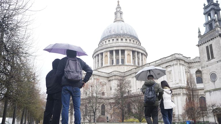 People walking in the rain by St. Paul&#39;s Cathedral in London. Parts of the UK face ice and heavy rain with the potential for flooding as the holiday period continues. Picture date: Wednesday December 28, 2022. 