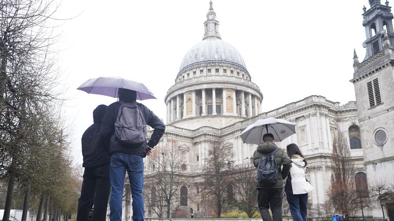 People walking in the rain by St. Paul&#39;s Cathedral in London. Parts of the UK face ice and heavy rain with the potential for flooding as the holiday period continues. Picture date: Wednesday December 28, 2022.
