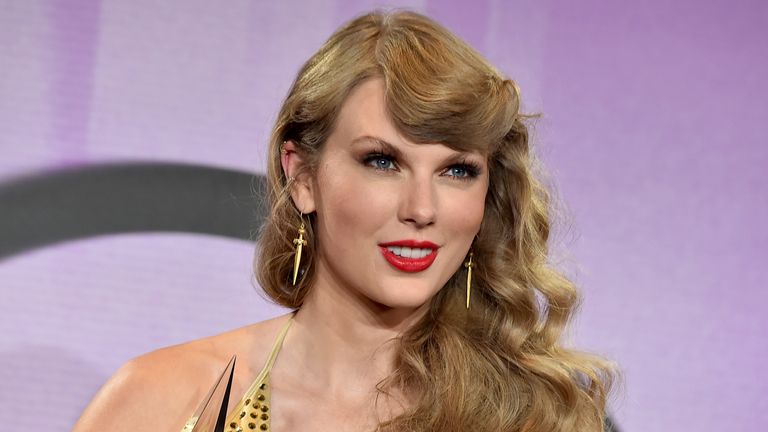 Taylor Swift poses in the press room with the awards for artist of the year, favorite music video for "All Too Well: The Short Film," favorite female pop artist, favorite pop album for "Red (Taylor&#39;s Version)," favorite female country artist and favorite country album for "Red (Taylor&#39;s Version)" at the American Music Awards on Sunday, Nov. 20, 2022, at the Microsoft Theater in Los Angeles. (Photo by Jordan Strauss/Invision/AP)