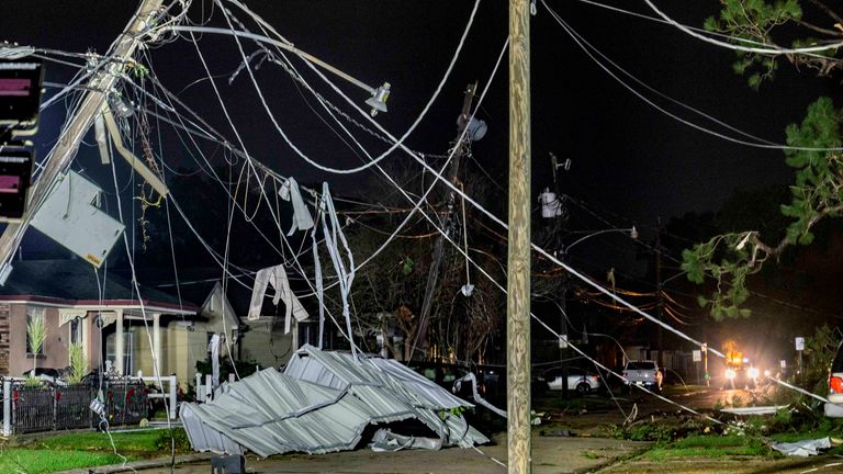 Power lines and metal roofs are seen in the tornado-damaged community of Gretna, La., Wednesday, Dec. 12, in Jefferson Parish near New Orleans.  14th, 2022. AP Photo/Matthew Hinton)