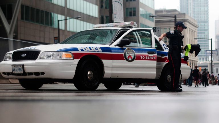 A police officer gets out her car in Toronto, Canada.