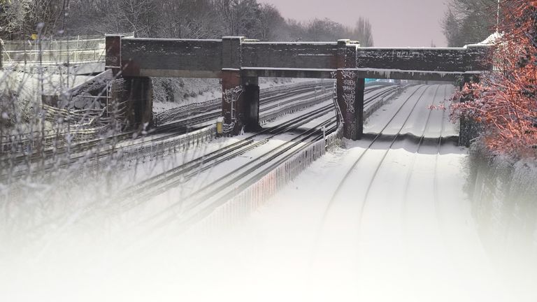 Snow covering the rail tracks for the London Underground lines in Willesden Green, north west London. Snow and ice have swept across parts of the UK, with cold wintry conditions set to continue for days. Picture date: Monday December 12, 2022.