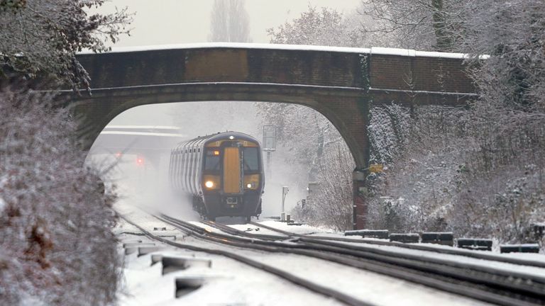 A Southeastern train makes its way through Ashford in Kent as rail services remain disrupted in the icy weather. Snow and ice have swept across parts of the UK, with cold wintry conditions set to continue for days. Picture date: Monday December 12, 2022.