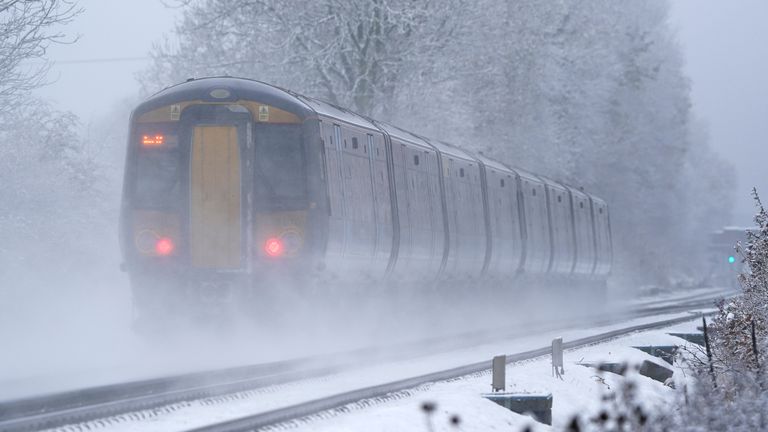 A Southeastern train makes its way through Ashford in Kent as rail services remain disrupted in the icy weather. Snow and ice have swept across parts of the UK, with cold wintry conditions set to continue for days. Picture date: Monday December 12, 2022.