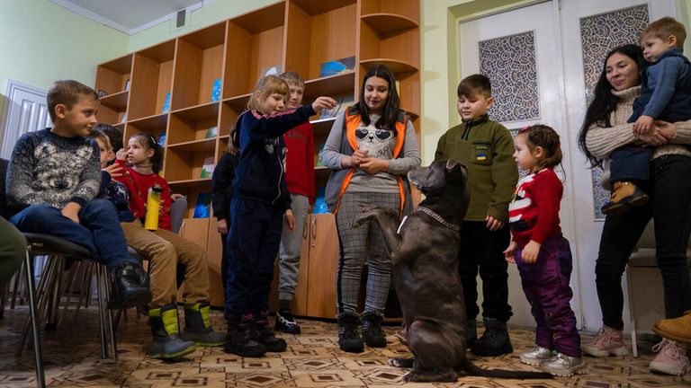 Children traumatized by the war play with an American Pit Bull Terrier "Bice" in the Center for Social and Psychological Rehabilitation in Boyarka close Kyiv, Ukraine, Wednesday, Dec. 7, 2022.
