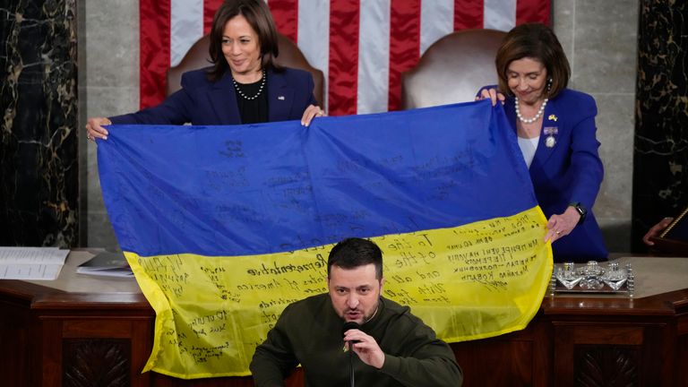 Vice President Kamala Harris and House Speaker Nancy Pelosi of Calif., right, react as Ukrainian President Volodymyr Zelenskyy presents lawmakers with a Ukrainian flag autographed by front-line troops in Bakhmut, in Ukraine&#39;s contested Donetsk province, as he addresses a joint meeting of Congress on Capitol Hill in Washington, Wednesday, Dec. 21, 2022. (AP Photo/Jacquelyn Martin)