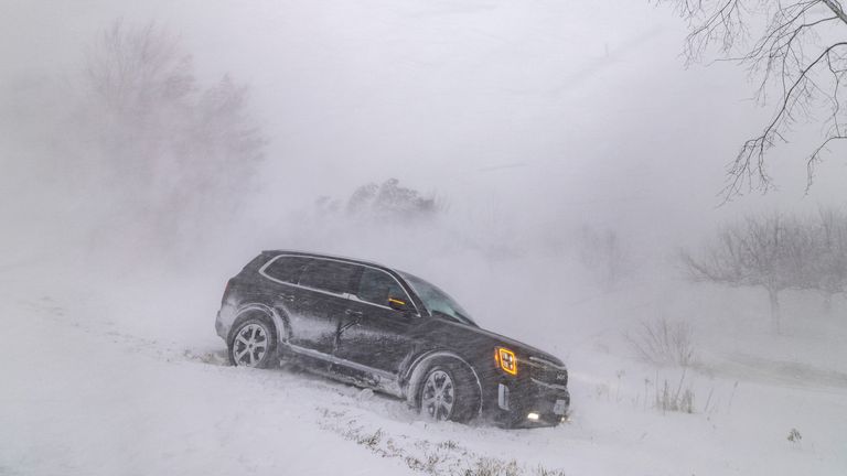 A car drove into a ditch during a winter storm near Wainfleet Ontario, Canada December 24, 2022. REUTERS/Carlos Osorio