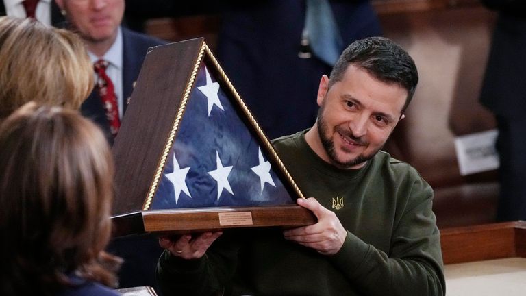 Ukrainian President Volodymyr Zelenskyy holds an American flag that was gifted to him by House Speaker Nancy Pelosi. Pic: AP/J. Scott Applewhite