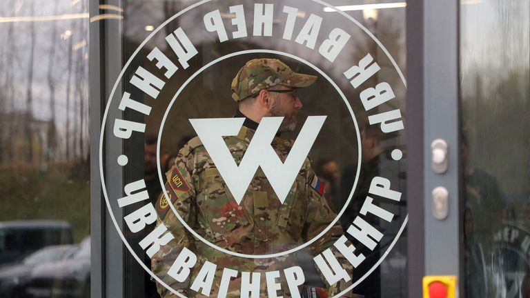 FILE PHOTO: A man wearing a camouflage uniform walks out of PMC Wagner Centre, which is a project implemented by the businessman and founder of the Wagner private military group Yevgeny Prigozhin, during the official opening of the office block in Saint Petersburg, Russia, November 4, 2022. REUTERS/Igor Russak/File Photo