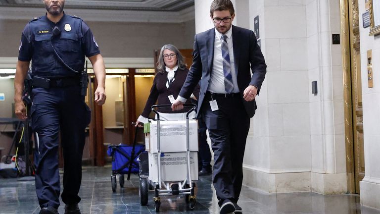 U.S. Capitol Police escort U.S. House Ways and Means Committee staff members as they transport boxes of documents after a committee meeting to discuss former President Donald Trump&#39;s tax returns on Capitol Hill in Washington, U.S., December 20, 2022. REUTERS/Evelyn Hockstein
