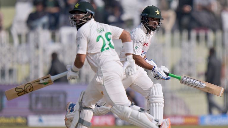 Pakistan&#39;s Abdullah Shafique, right, and Imam-ul-Haq run between the wickets during the second day of the first test cricket match between Pakistan and England, in Rawalpindi, Pakistan, Friday, Dec. 2, 2022. (AP Photo/Anjum Naveed)