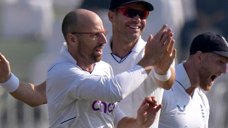 England&#39;s Jack Leach, left, celebrates with teammates after taking the wicket of Pakistan&#39;s Imam-ul-Haq during the third day of the first test cricket match between Pakistan and England, in Rawalpindi, Pakistan, Saturday, Dec. 3, 2022. (AP Photo/Anjum Naveed)