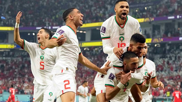 Morocco&#39;s Hakim Ziyech (7) celebrates after scoring his side&#39;s opening goal with team mate Azzedine Ounahi, top center, Youssef En-Nesyri, top, Achraf Hakimi (2), Nayef Aguerd (5) and background, and Sofyan Amrabat, right, during the World Cup group F soccer match between Canada and Morocco at the Al Thumama Stadium in Doha , Qatar, Thursday, Dec. 1, 2022. (AP Photo/Pavel Golovkin)