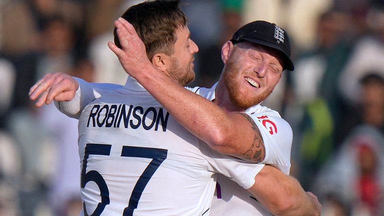 England&#39;s Ollie Robinson, left, celebrates with Ben Stokes after taking the wicket of Pakistan Abdullah Shafique during the fourth day of the first test cricket match between Pakistan and England, in Rawalpindi, Pakistan, Sunday, Dec. 4, 2022. (AP Photo/Anjum Naveed)