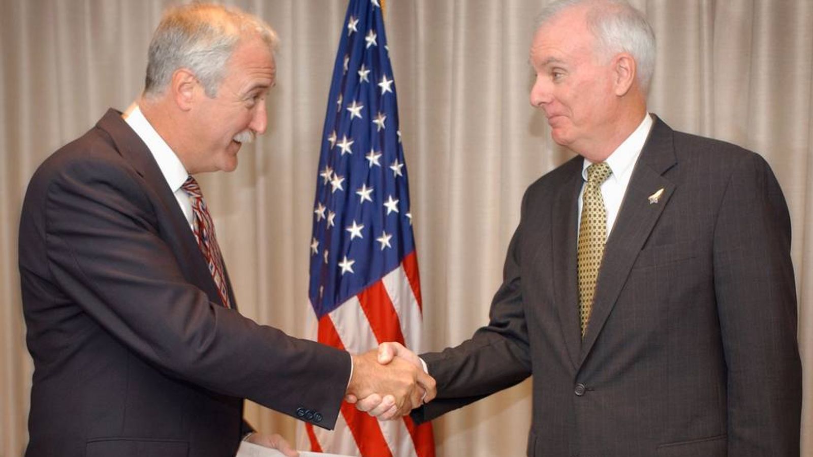 Sean O'Keefe accepts a copy of the report from Admiral Harold Gehman