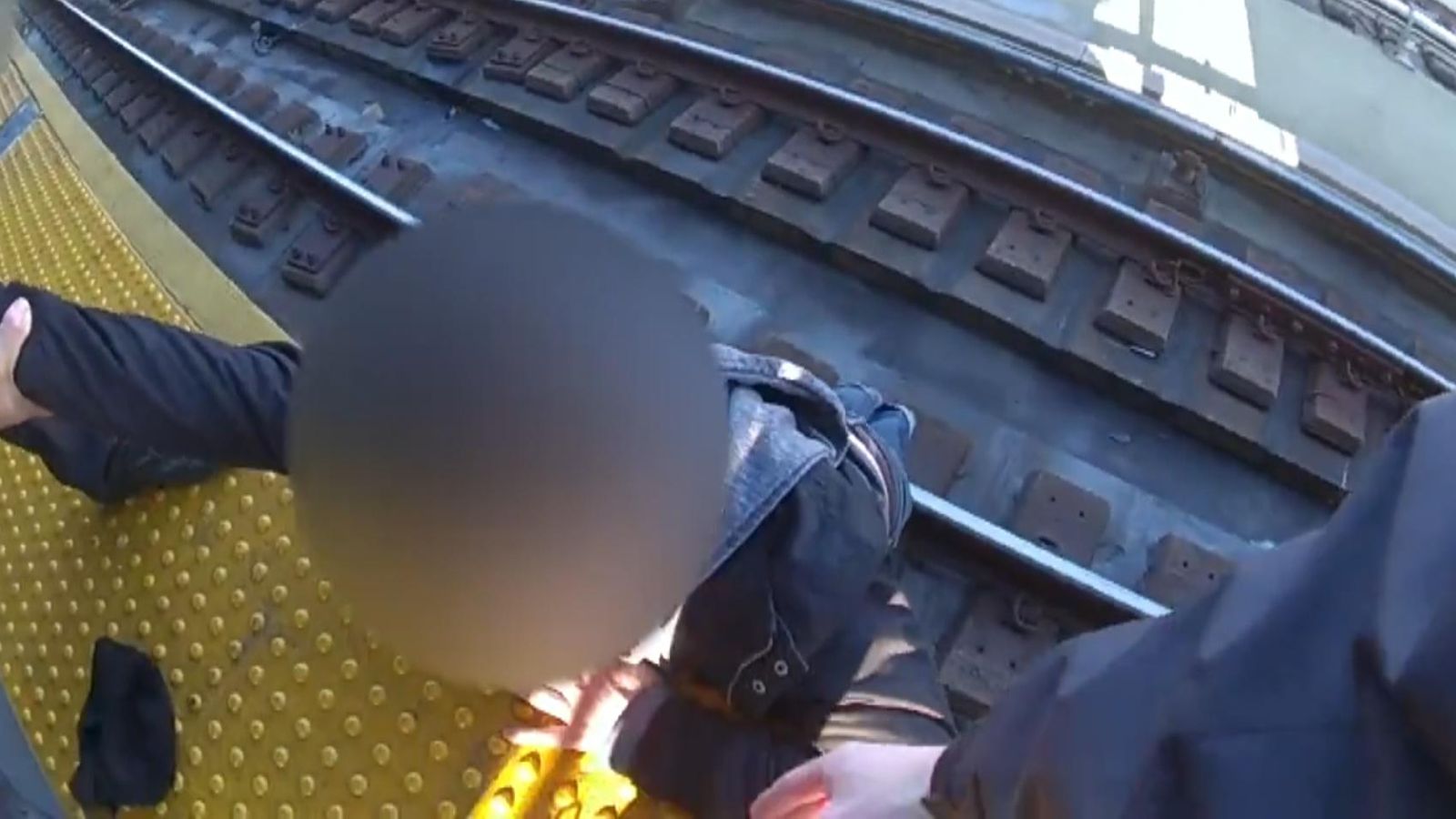 New York: Man rescued after falling on to train tracks at Brooklyn ...