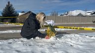 Mourner Sharon Huntsman, a member of the local church, tearfully laid flowers at the crime scene in Utah today. Picture: AP